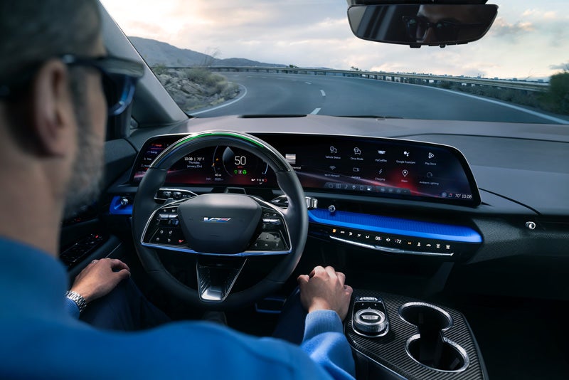 Front View of the 2026 OPTIQ-V Driving Through the Dusk Utilizing its Headlights | Ritchey Cadillac in DAYTONA BEACH FL