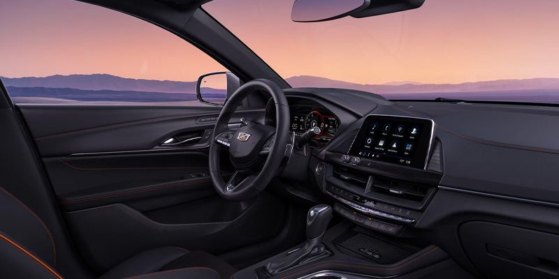 Side profile of a silver 2025 Cadillac CT4 showcasing sleek body lines