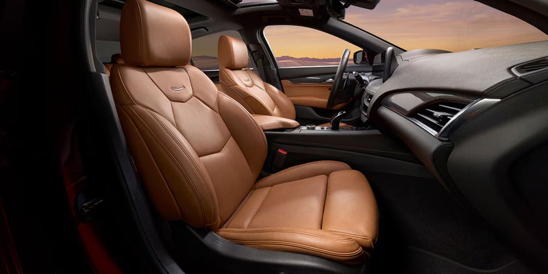Front seating area of the 2025 Cadillac CT4 featuring tan leather seats and a premium cabin layout.