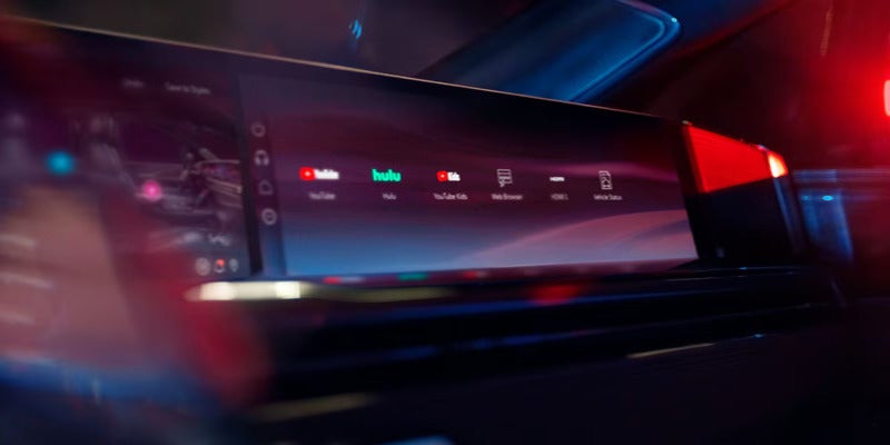 Close-up of Cadillac Escalade IQ infotainment screen showing streaming apps like YouTube and Hulu