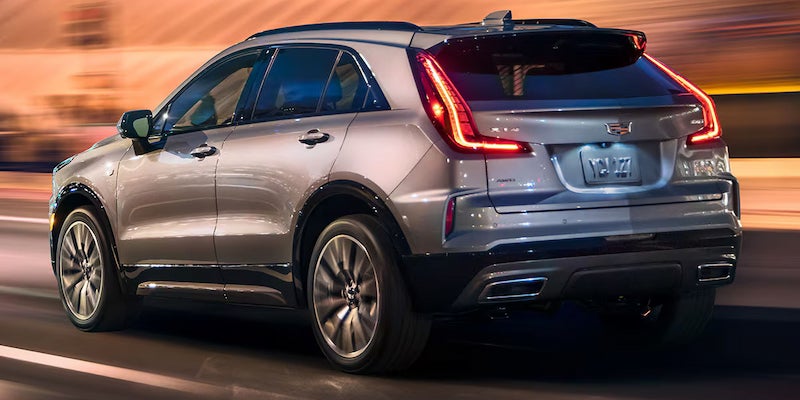 Rear three-quarter view of the 2025 Cadillac XT4 driving at night