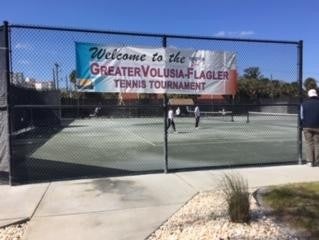 Tennis courts with tournment banner on the fence